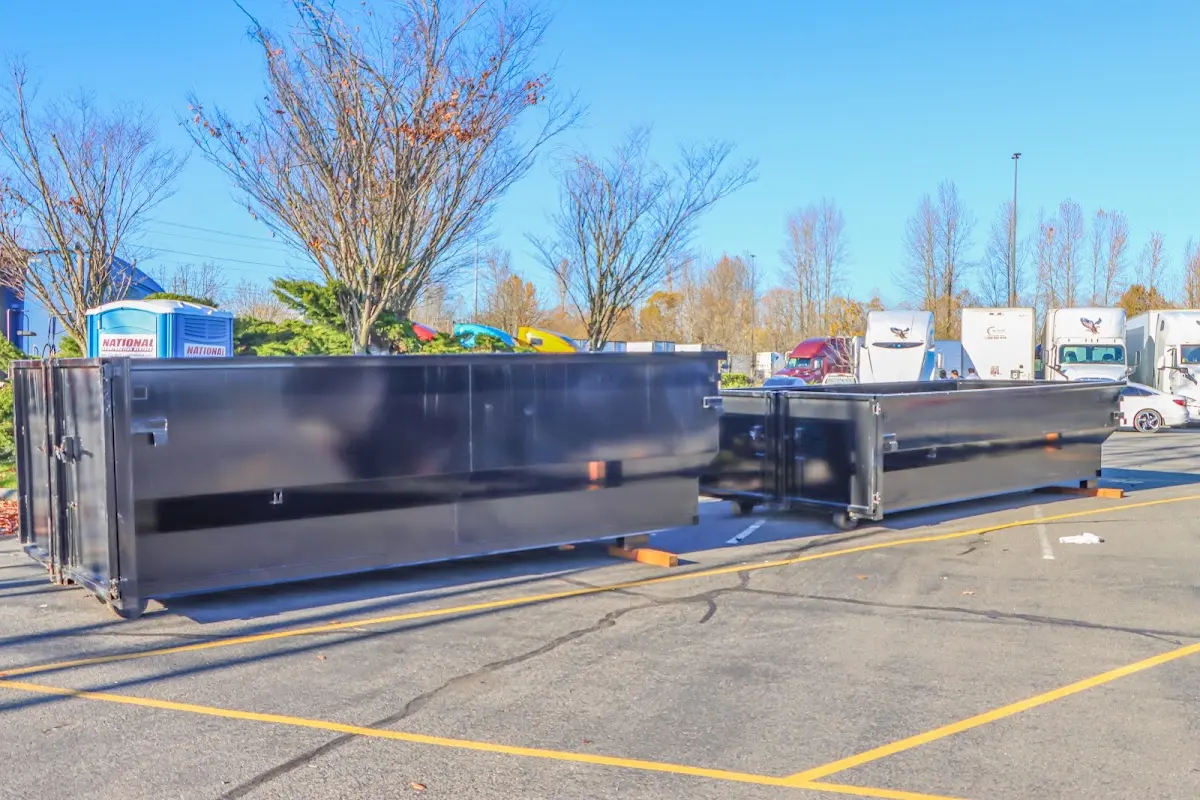 Professional dumpster rental service with roll-off container on residential driveway in Mill Creek East